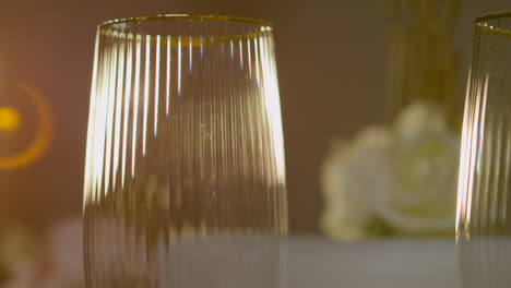 Close-Up-Of-Gold-Rimmed-Glass-On-Table-Set-For-Meal-At-Wedding-Reception-Or-Restaurant